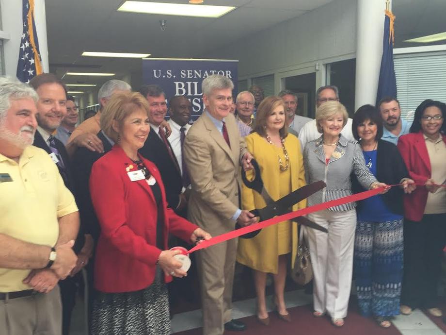 Cutting the ceremonial ribbon at my Alexandria office opening.